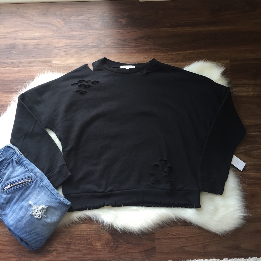 Long sleeve distressed French terry top.